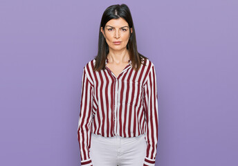 Wall Mural - Beautiful brunette woman wearing striped shirt depressed and worry for distress, crying angry and afraid. sad expression.