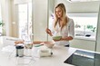 © Krakenimages.com - Young blonde woman smiling confident pouring flour on bowl at kitchen
