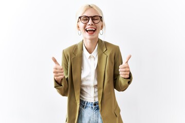 Sticker - Beautiful caucasian business woman standing over isolated background success sign doing positive gesture with hand, thumbs up smiling and happy. cheerful expression and winner gesture.