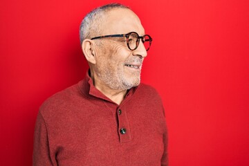 Poster - Handsome mature man wearing casual sweater and glasses looking to side, relax profile pose with natural face and confident smile.