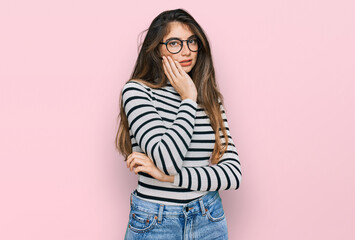 Sticker - Young beautiful teen girl wearing casual clothes and glasses thinking looking tired and bored with depression problems with crossed arms.