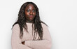 © Krakenimages.com - Young african woman wearing wool winter sweater skeptic and nervous, disapproving expression on face with crossed arms. negative person.