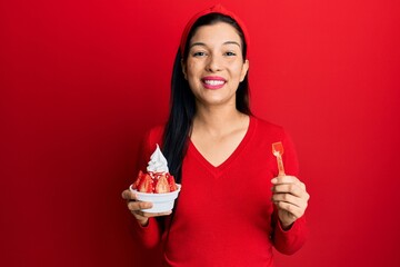 Poster - Young latin woman holding ice cream smiling with a happy and cool smile on face. showing teeth.