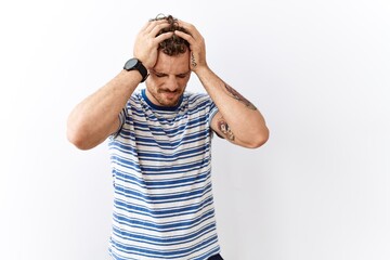 Poster - Handsome young man standing over isolated background suffering from headache desperate and stressed because pain and migraine. hands on head.