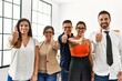© Krakenimages.com - Group of business workers smiling happy doing ok sign with thumbs up at the office.