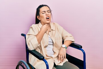 Canvas Print - Young hispanic woman sitting on wheelchair touching painful neck, sore throat for flu, clod and infection