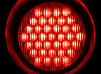 Bright round red light in the dark, object macro, detail, closeup, circle shape, nobody. Red alert, emergency alarm, warning, anxiety, stop abstract design concept, modern background texture, backdrop