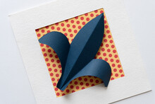 Blue Paper Fleur-de-lys On Paper With Dot Pattern Inside A Paper Frame