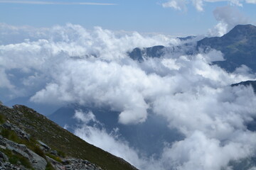 blue sky and white clouds over the rock of Bric Bouchet between the French alps of the Queyras region on the French-Italian border