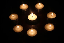 Light Several Candles On A Wooden Table