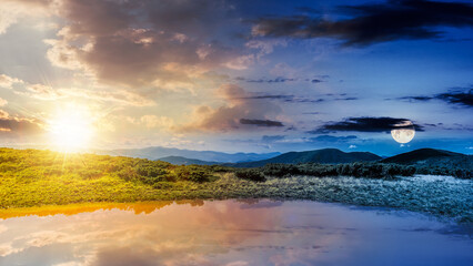Wall Mural - day and night time change concept above landscape with lake in summer. peaceful reflection in the wa