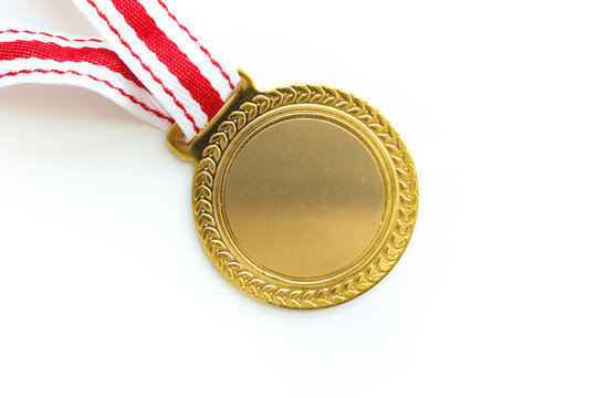 Top view of blank golden medal with red-white ribbon isolated on white background with copy space.