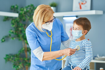 Pediatrician doctor examining little kids in clinic