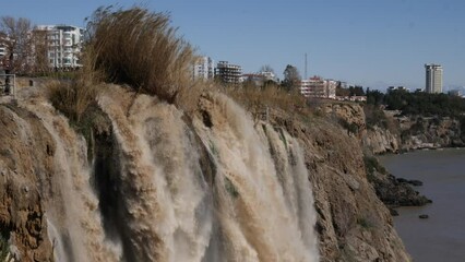Wall Mural - antalya duden waterfall touristic town mediterranean turkey muddy water after rain city on the cliff