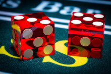 A Macro Photograph Of Professional Casino-style Dice Sitting On The Pass Section Of A Craps Table.