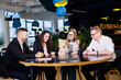 © DSMT - Businessmen play jenga. Business holiday concept. Young people play board games in the office