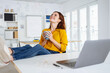 © contrastwerkstatt - Happy young businesswoman smiling in gleeful anticipation