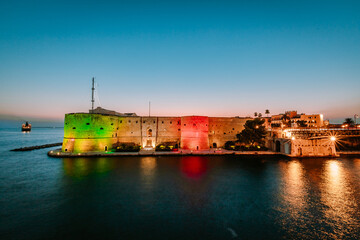 Wall Mural - Aragonese Castle of Taranto illuminated at sunset in summer