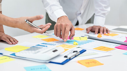 Poster - Two business people pointing keyword in post it notes on the table during brainstorming about new business project