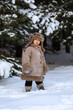 © IrinaStrelnikova - A cute boy in a fur coat and a hat with earflaps walks in winter