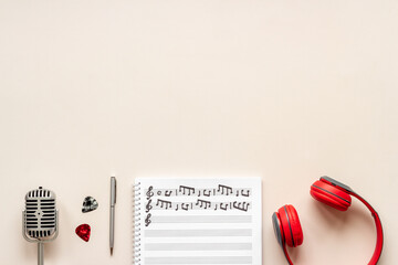 Wall Mural - Handwritten music sheets and headphones, top view. Compose music concept