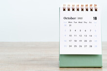 October 2022 Desk Calendar On Wooden Background.