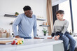 © Yakobchuk Olena - Multiracial father and his caucasian son communicating at the cozy kitchen