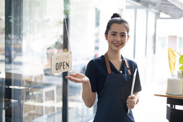 Portrait of asian woman barista cafe owner smile while cafe open. SME entrepreneur seller business concept.