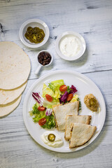 Wall Mural - chicken quesadilla with rice, beans, salad, chalapenos and salsa