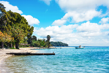 Wall Mural - beautiful scenic landscape with a boat in the bay near the beach in nydri, lefkada, greece. stunning