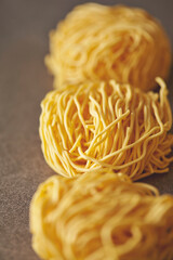 Poster - Dried Homemade Pasta Noodles on Gray Background