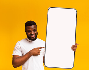 Black guy pointing at white empty smartphone screen