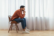 canvas print picture - Pensive Arab man sitting on chair and thinking