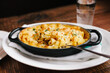 Mac and Cheese with butternut squash and bacon in a cast iron dish