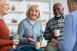 © Prostock-studio - Multiracial group of positive elderly people drinking tea, chatting