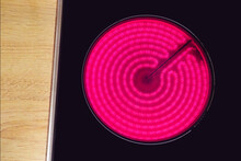Red hot glass ceramic cooktop burner flame. Glowing burner of the electric hotplate, top view