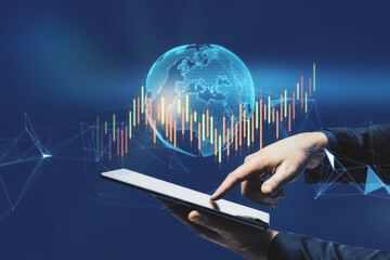 Aufkleber - Close up of businessman hand pointing at tablet with glowing polygonal globe and candlestick forex chart. Trade, technology and communication concept. Double exposure.