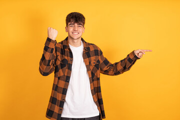 Poster - isolated teenager pointing with astonished expression