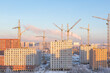 Construction of apartment buildings in new Moscow, cranes, skyscraper towers in winter