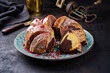 Traditional exotically bundt marble cocoa chocolate cake with icing sugar glaze and freeze dry raspberry topping served as close-up on a Nordic design plate