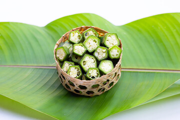 Sticker - Fresh okra on green leaf on white background