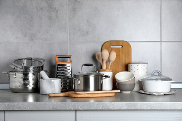 Wall Mural - Set of different cooking utensils on grey countertop in kitchen