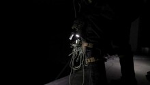 Close Up Of Paracord Knot With Rifle Sling And Tactical Gun Fighter Military Operation Rappel Down The Interior Of A Dark Building, Gearing Up In Preparation For Assault