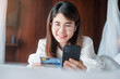 © Jo Panuwat D - woman using mobile smart phone and credit card for online shopping while making order on bed in morning at home. technology, ecommerce, digital banking online payment and apartment living concept