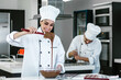 © Marcos - latin woman pastry chef wearing uniform holding a bowl preparing delicious sweets chocolates at kitchen in Mexico Latin America