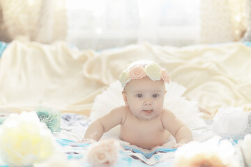 Wall Mural - A newborn baby is lying on a soft bed.