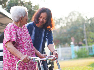 Portrait of old mother with cheerful woman taking care of her mom. Happy Asian senior family concept.