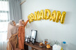 © Odua Images - mother and daughter Muslim decorating house with ramadan
