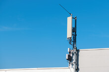 Cellular Phone Signal Repeater Antenna Mounted On Top Of Industrial Building