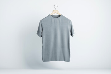 Wall Mural - Blank grey t-shirt hanging in the air with copyspace for your text on light backdrop. 3D rendering, mockup
